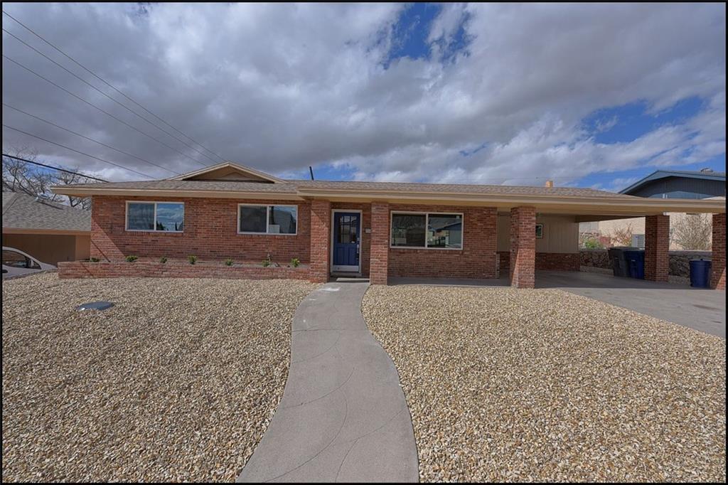 325 Coral Hills Road El Paso, TX 79912 - Photo 1 of 1 a front view of a house with a yard and garage