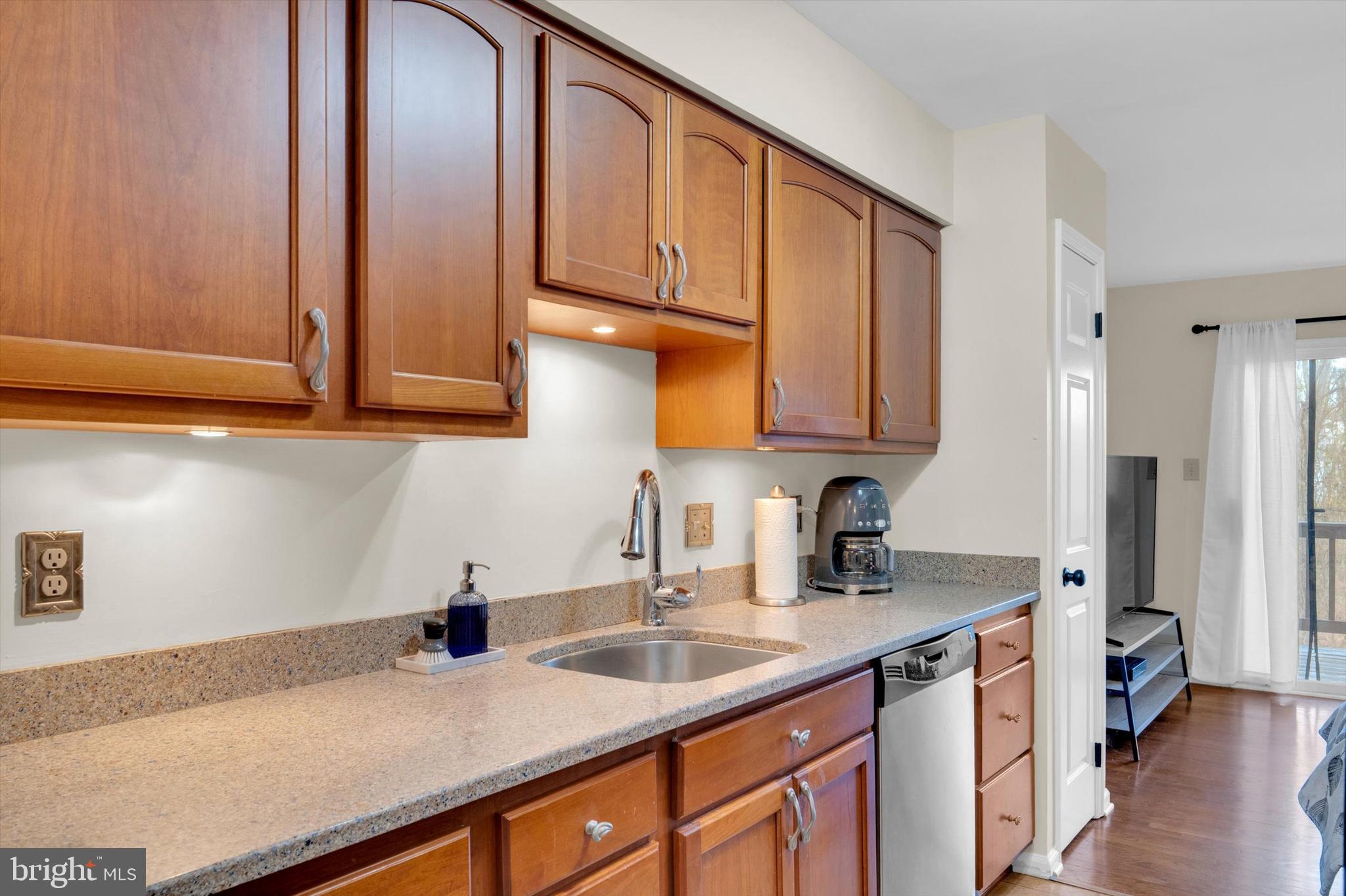 13201 Valley Bridge Court Silver Spring, MD 20906 - Photo 11 of 42 a kitchen with stainless steel appliances granite countertop a sink a stove and cabinets