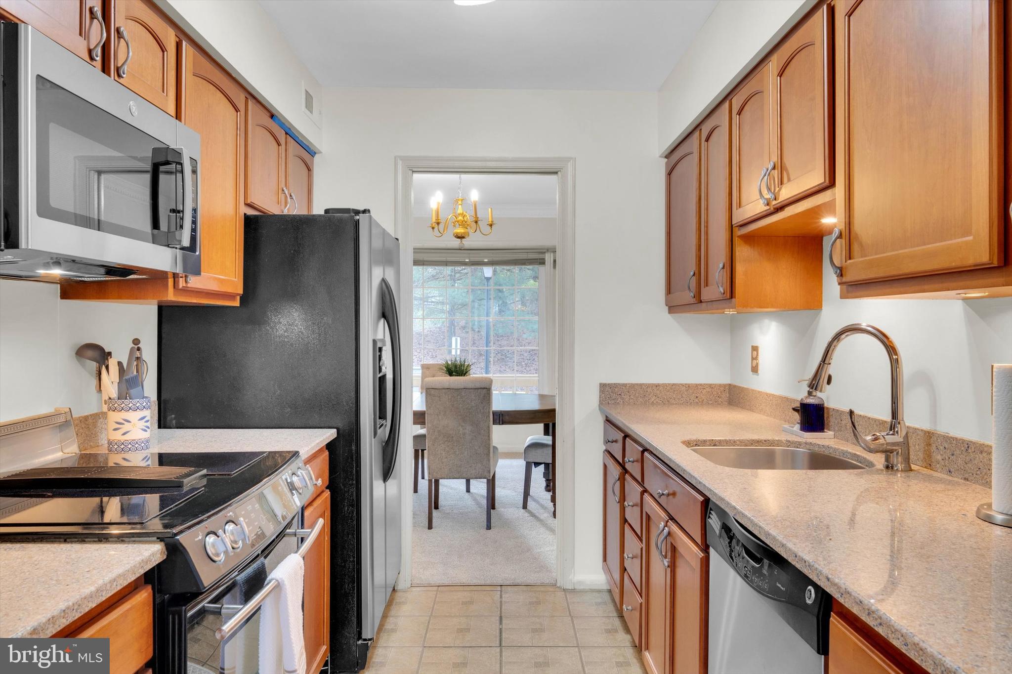 13201 Valley Bridge Court Silver Spring, MD 20906 - Photo 12 of 42 a kitchen with stainless steel appliances granite countertop a sink stove and refrigerator