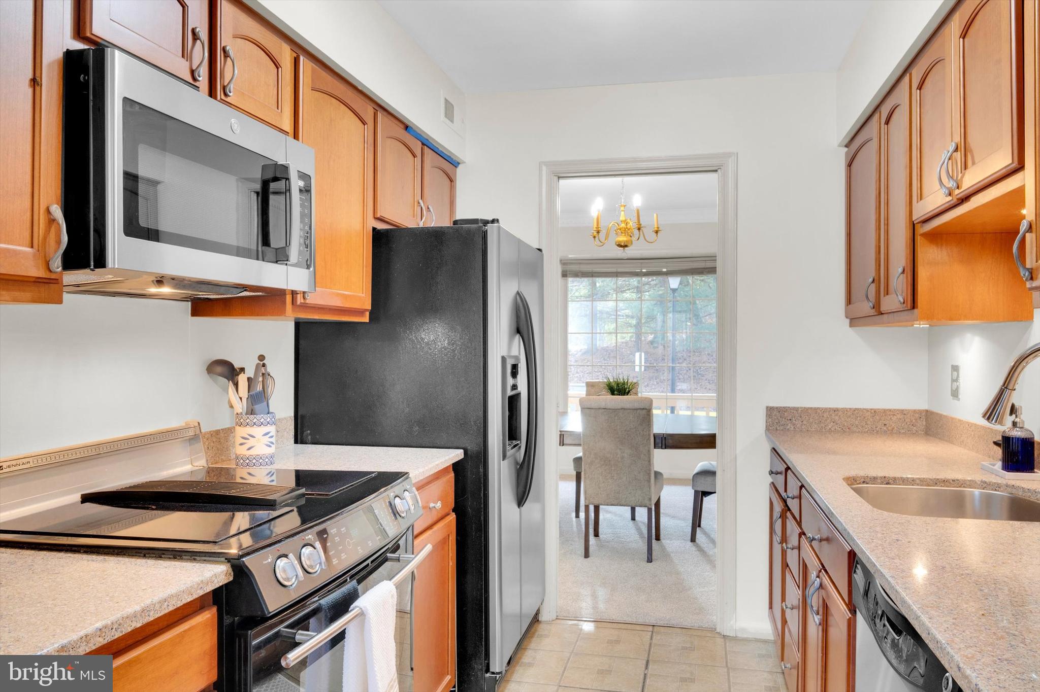 13201 Valley Bridge Court Silver Spring, MD 20906 - Photo 13 of 42 a kitchen with stainless steel appliances a stove a sink and a microwave