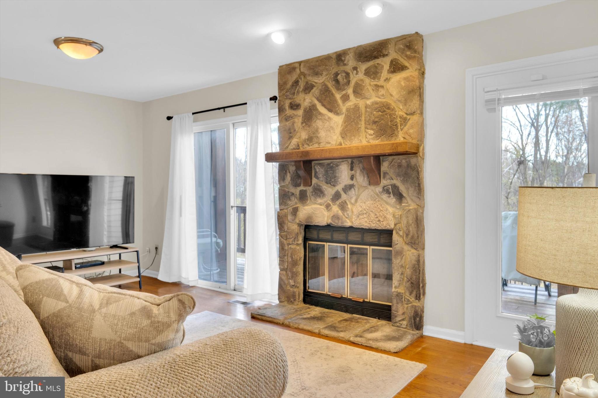 13201 Valley Bridge Court Silver Spring, MD 20906 - Photo 19 of 42 a living room with furniture and a fireplace