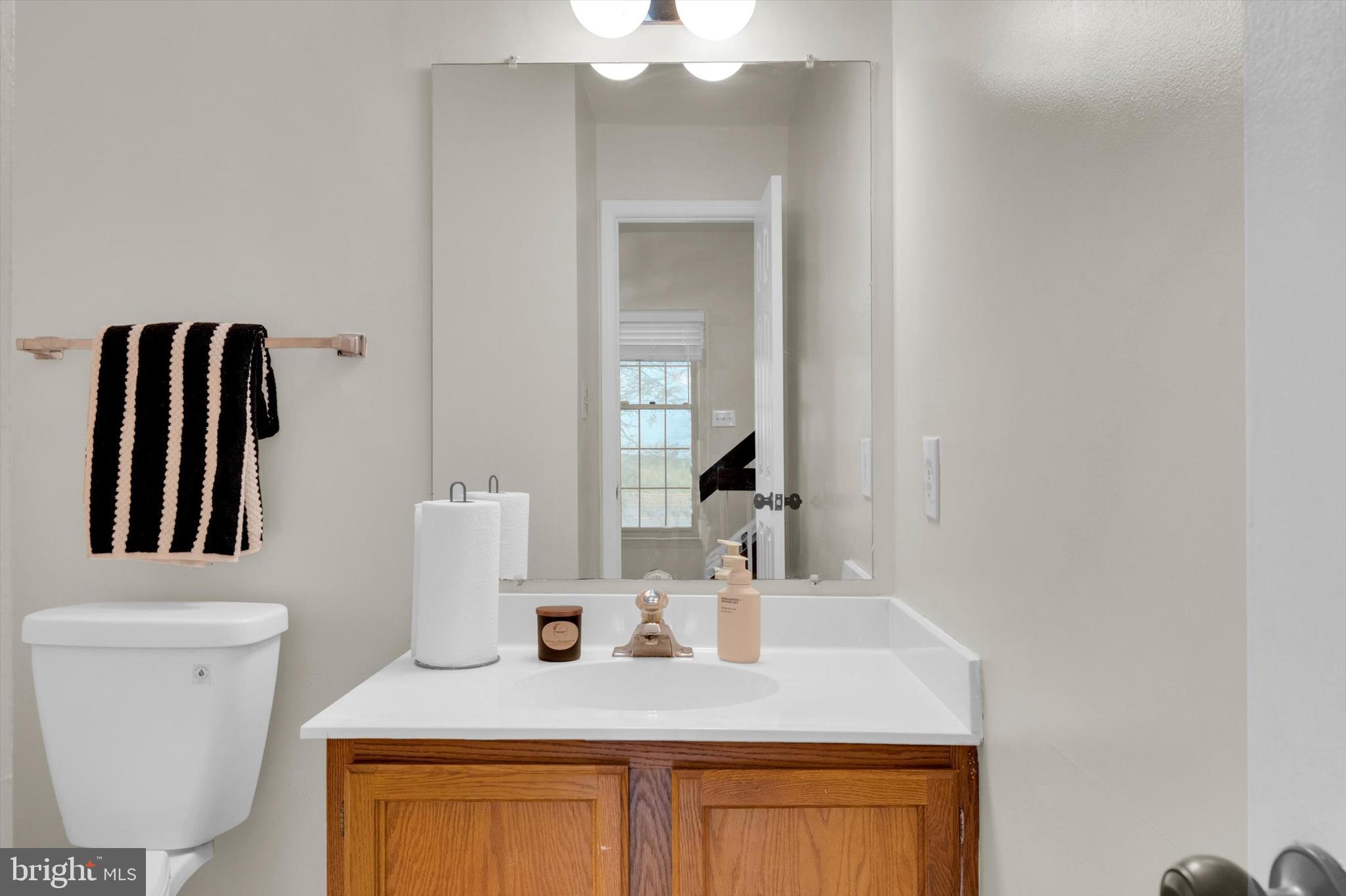 13201 Valley Bridge Court Silver Spring, MD 20906 - Photo 20 of 42 a bathroom with a sink a toilet and mirror