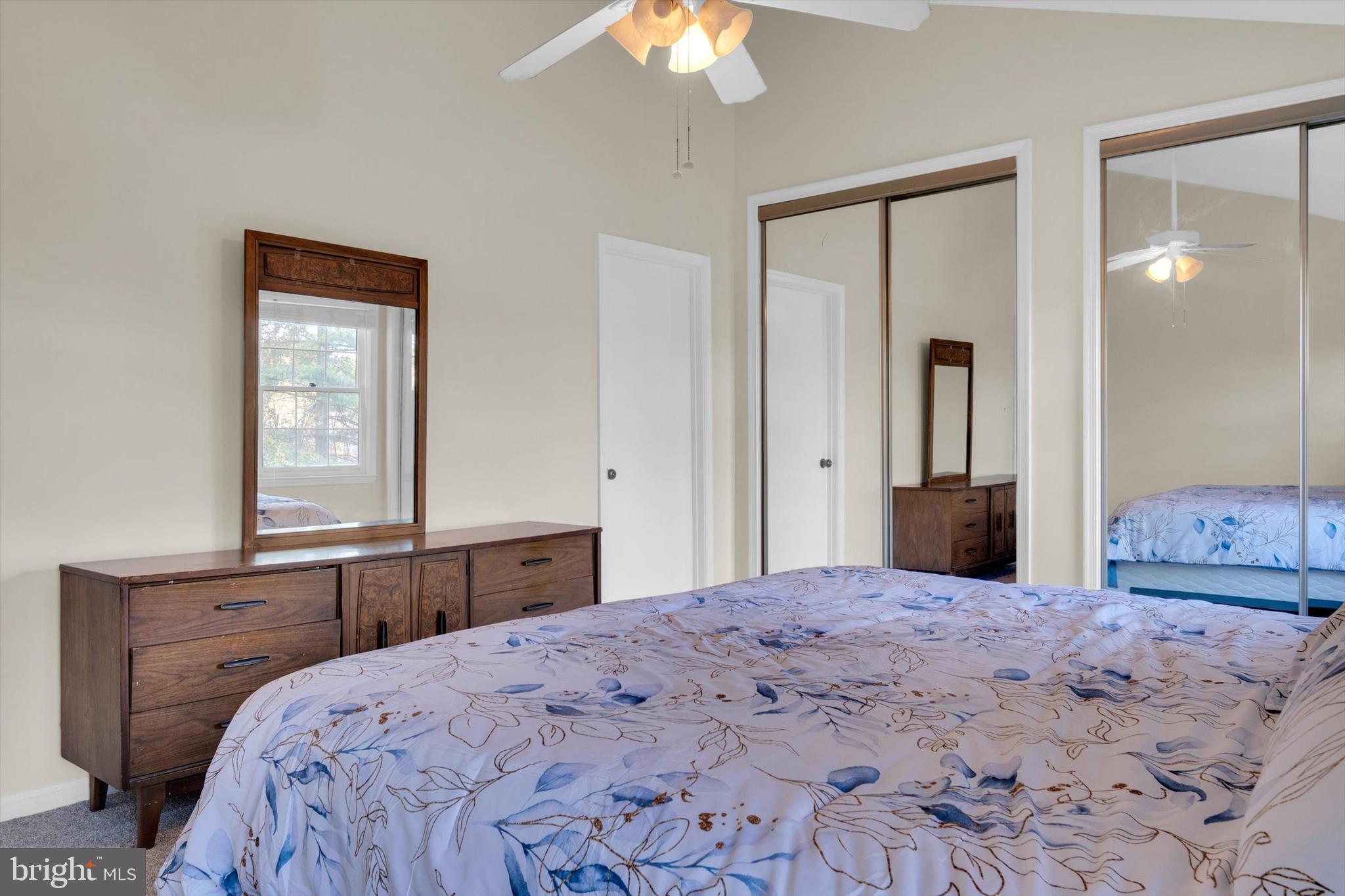 13201 Valley Bridge Court Silver Spring, MD 20906 - Photo 21 of 42 a bedroom with a large bed and a chandelier
