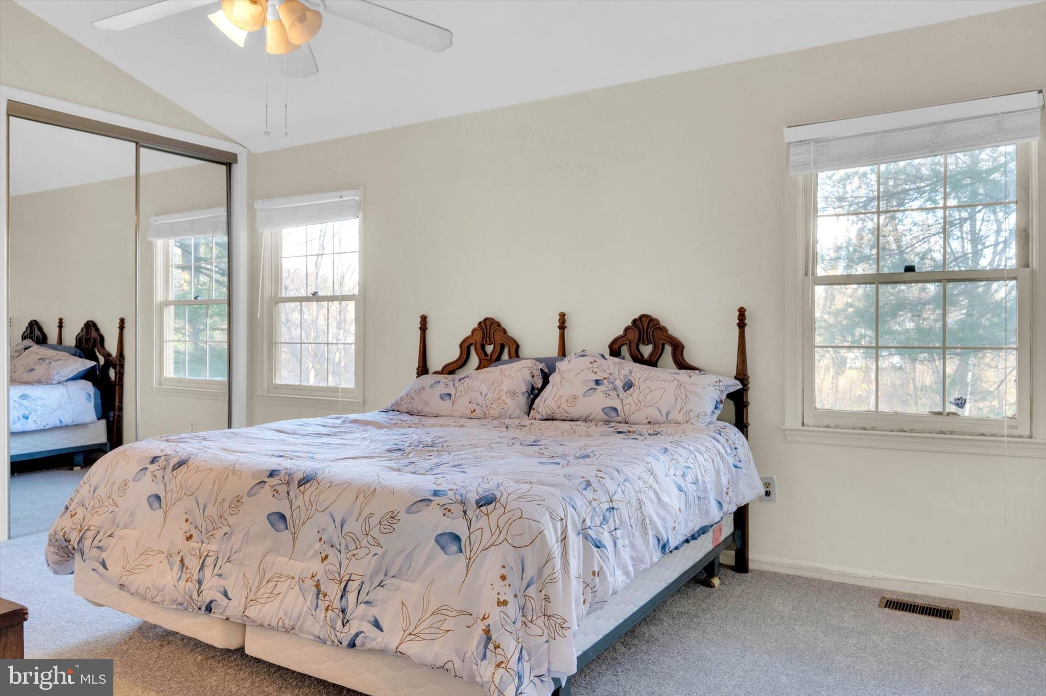 13201 Valley Bridge Court Silver Spring, MD 20906 - Photo 22 of 42 a bedroom with a bed and a lamp next to a window