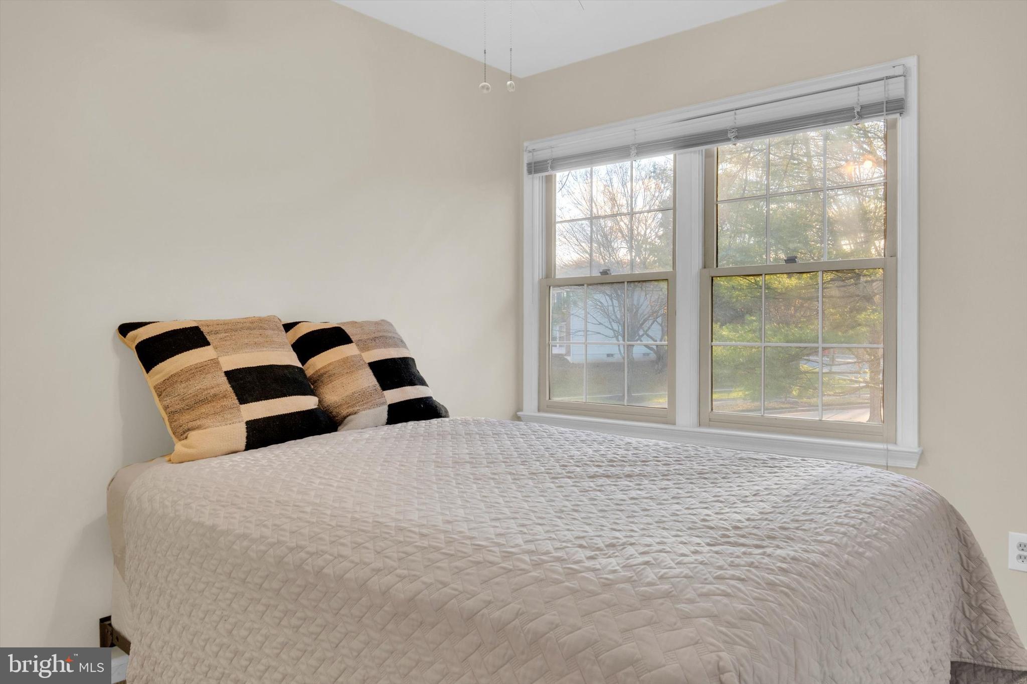 13201 Valley Bridge Court Silver Spring, MD 20906 - Photo 27 of 42 a bedroom with a large bed and a large window
