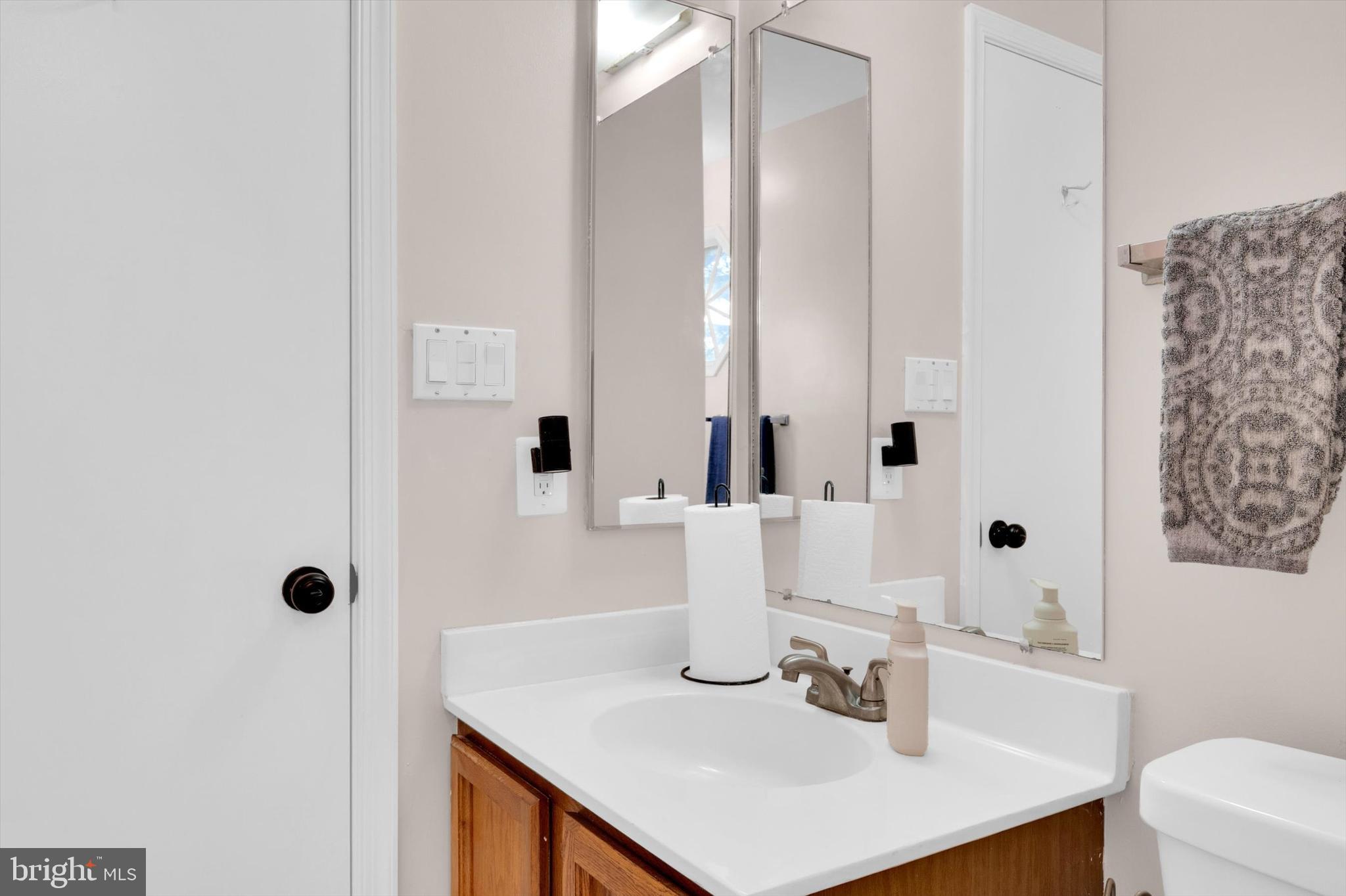 13201 Valley Bridge Court Silver Spring, MD 20906 - Photo 30 of 42 a bathroom with a sink and a mirror