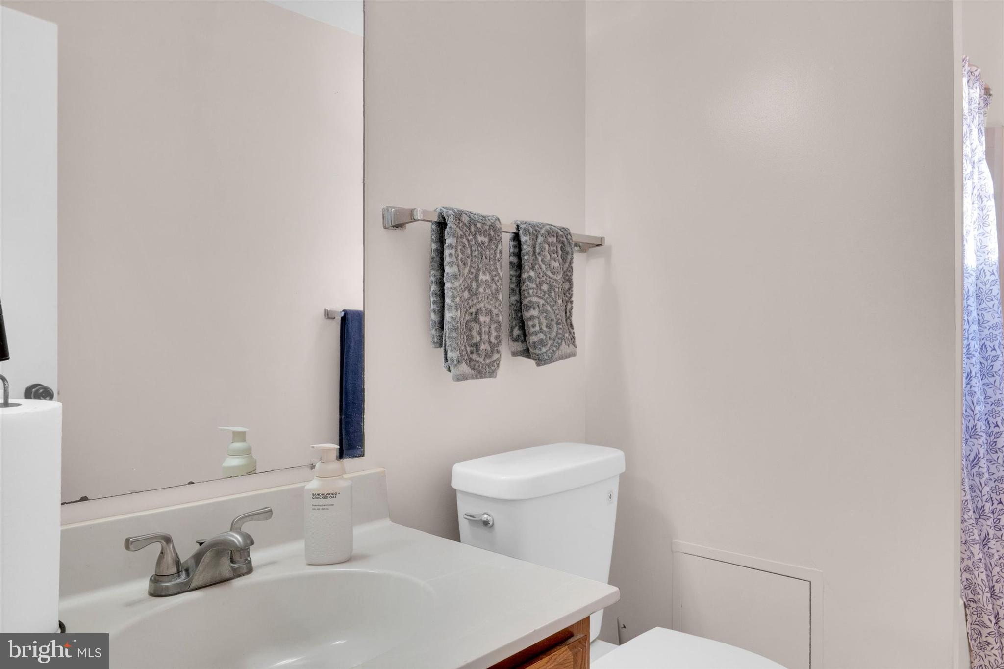 13201 Valley Bridge Court Silver Spring, MD 20906 - Photo 32 of 42 a bathroom with a sink toilet and mirror