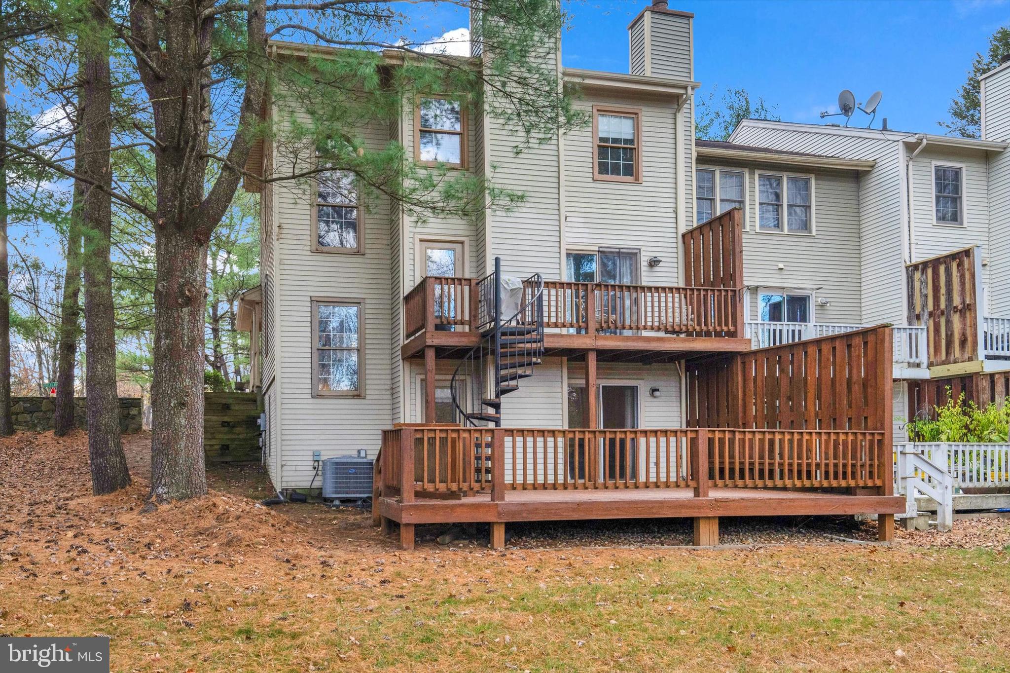 13201 Valley Bridge Court Silver Spring, MD 20906 - Photo 39 of 42 a view of a house with a wooden deck and furniture