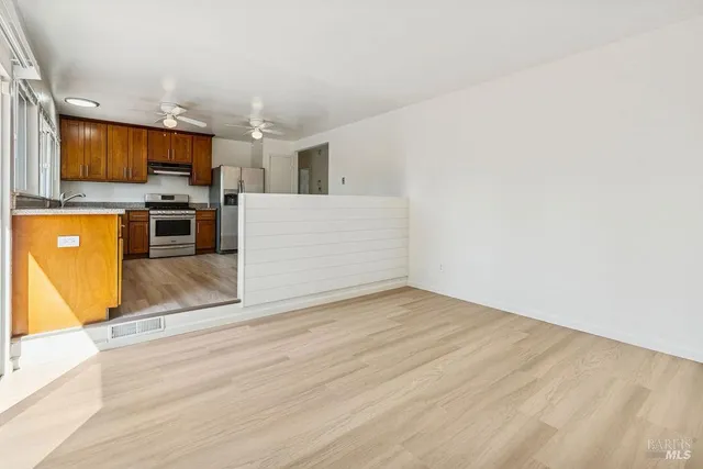 a view of kitchen with microwave and cabinets