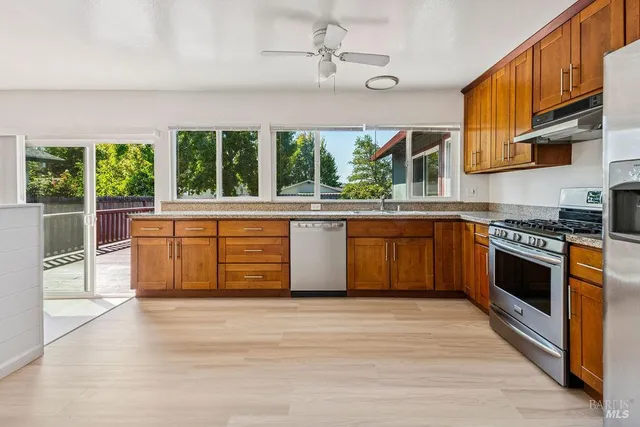 a kitchen with stainless steel appliances granite countertop a stove and a sink