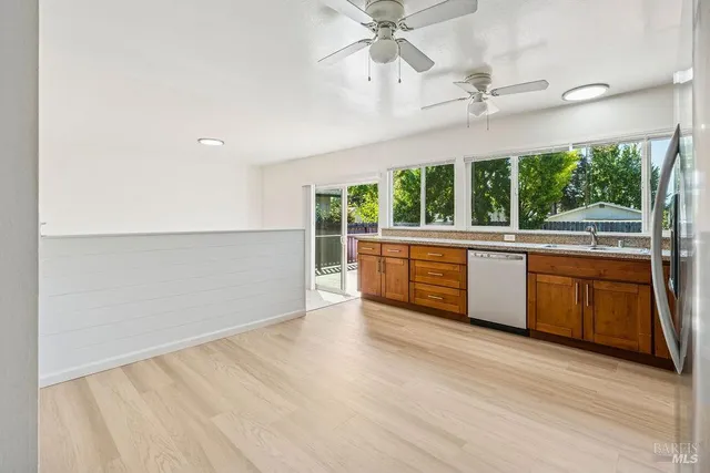 a large white kitchen with a large window