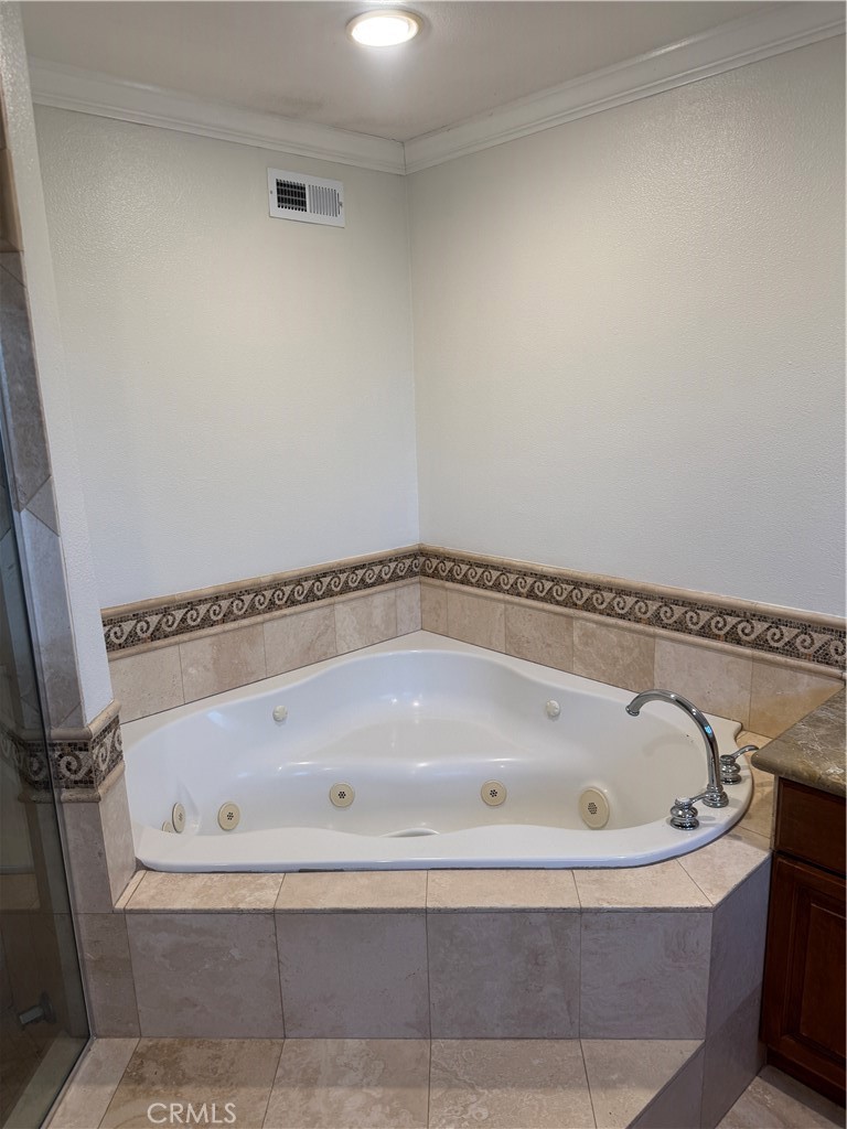 20182 Kline Drive Newport Beach, CA 92660 - Photo 16 of 39 a white bath tub sitting in a bathroom