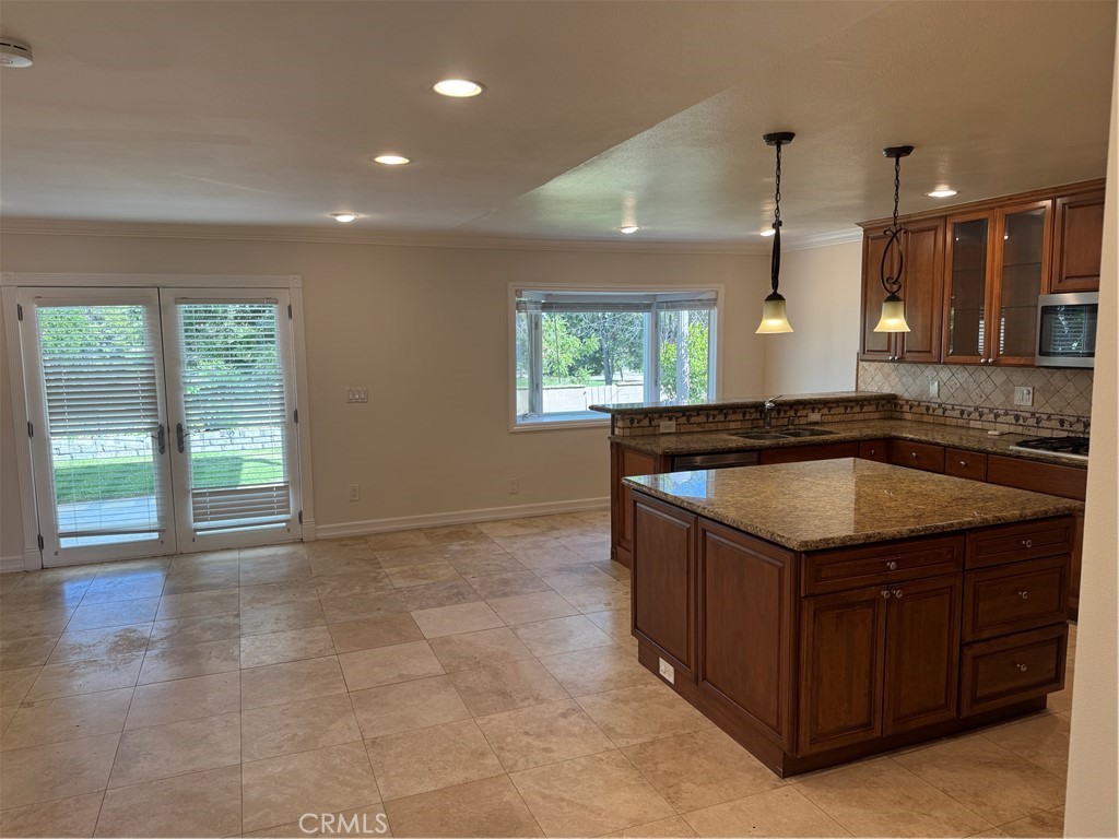 20182 Kline Drive Newport Beach, CA 92660 - Photo 5 of 39 a kitchen with granite countertop a sink and a stove
