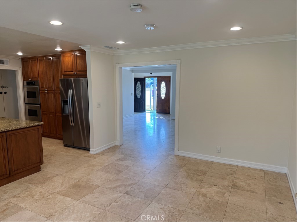 20182 Kline Drive Newport Beach, CA 92660 - Photo 6 of 39 an entryway in a hall with a cabinet and mirrors
