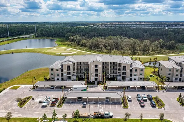 an aerial view of a house with a garden and lake view
