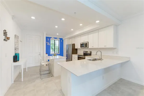 a kitchen with stainless steel appliances a sink and a window