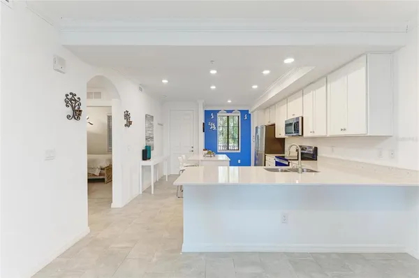 a kitchen with stainless steel appliances kitchen island a refrigerator sink and stove