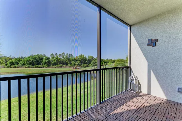 an aerial view of a house with a garden and lake view