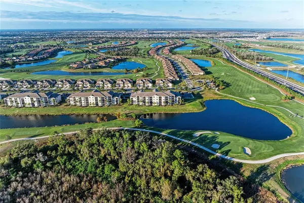 an aerial view of residential houses with outdoor space