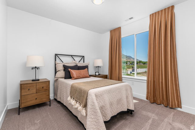 1352 West 2350 South, Unit 18 Perry, UT 84302 - Photo 18 of 26 Carpeted room featuring a large window with mountain scenery, white walls, and a recessed ceiling light