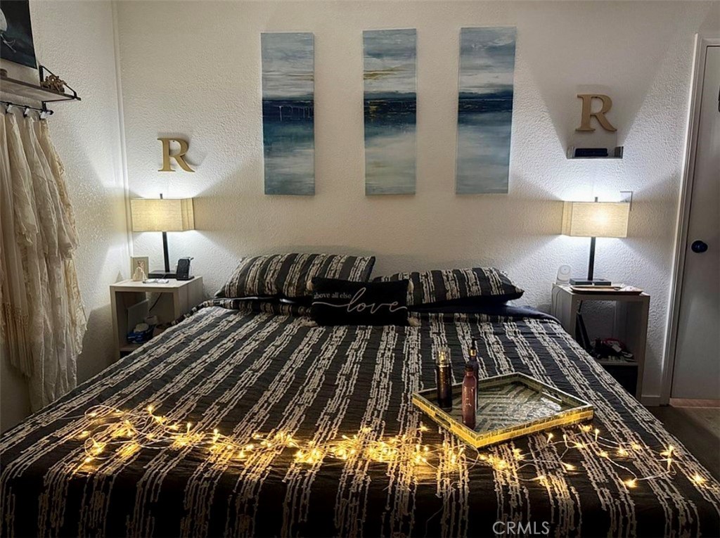 22601 Bear Valley Road, Unit 63 Apple Valley, CA 92308 - Photo 15 of 31 a bedroom with bed and a night stand