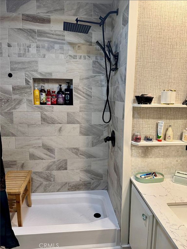 22601 Bear Valley Road, Unit 63 Apple Valley, CA 92308 - Photo 20 of 31 a bathroom with a granite countertop sink a mirror and shower