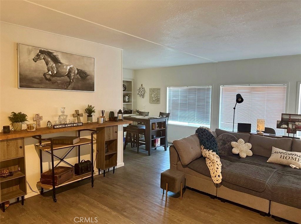 22601 Bear Valley Road, Unit 63 Apple Valley, CA 92308 - Photo 3 of 31 a living room with furniture and wooden floor