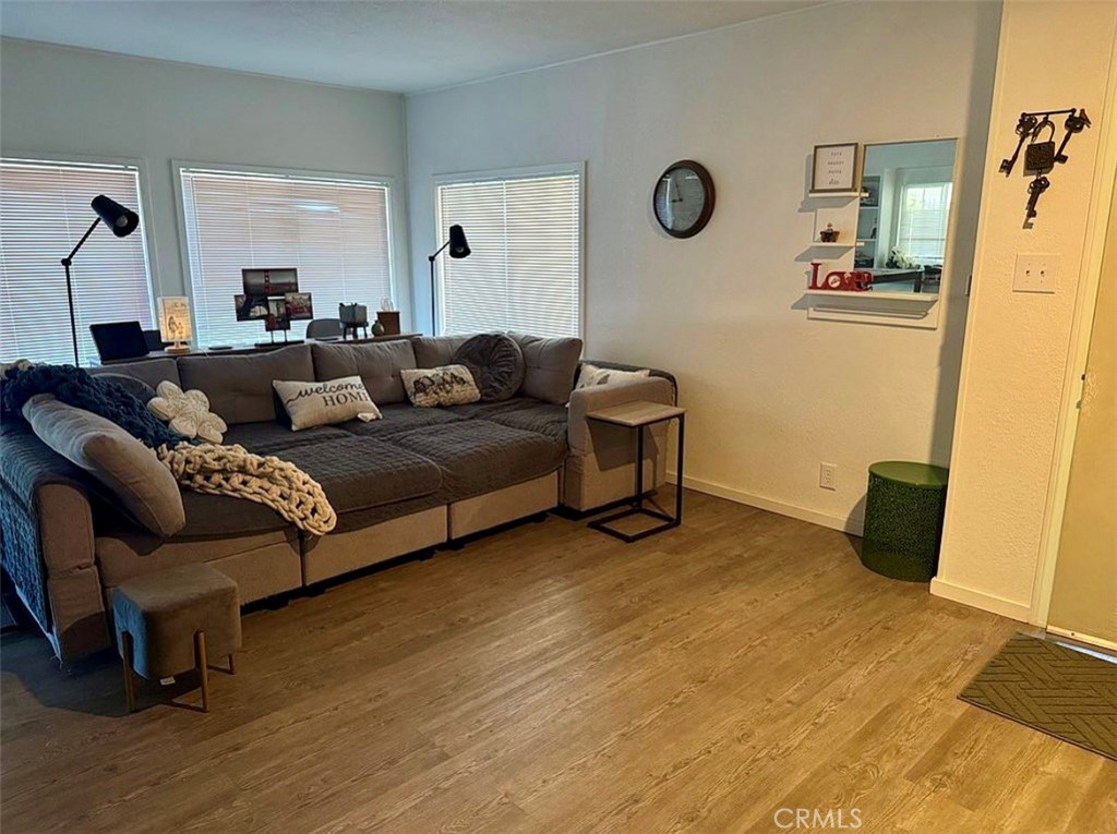 22601 Bear Valley Road, Unit 63 Apple Valley, CA 92308 - Photo 4 of 31 a living room with couch chairs and a table