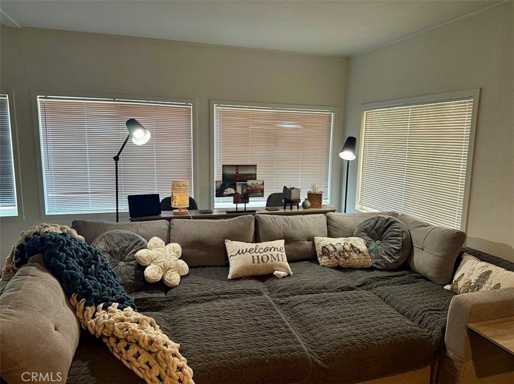 22601 Bear Valley Road, Unit 63 Apple Valley, CA 92308 - Photo 5 of 31 a living room with furniture and wooden floor