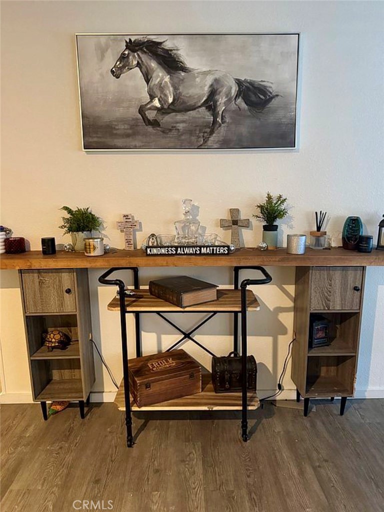 22601 Bear Valley Road, Unit 63 Apple Valley, CA 92308 - Photo 6 of 31 a view of a room with gym equipment and wooden floor