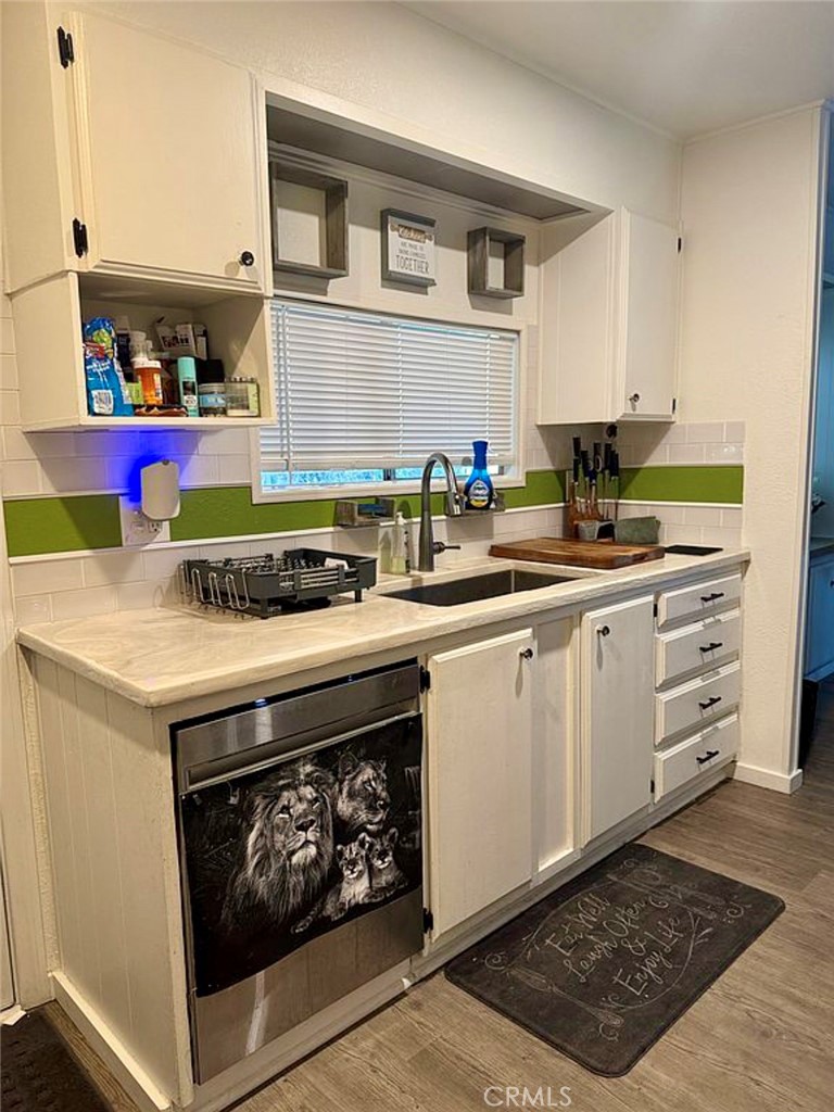 22601 Bear Valley Road, Unit 63 Apple Valley, CA 92308 - Photo 8 of 31 a kitchen with a stove and cabinets