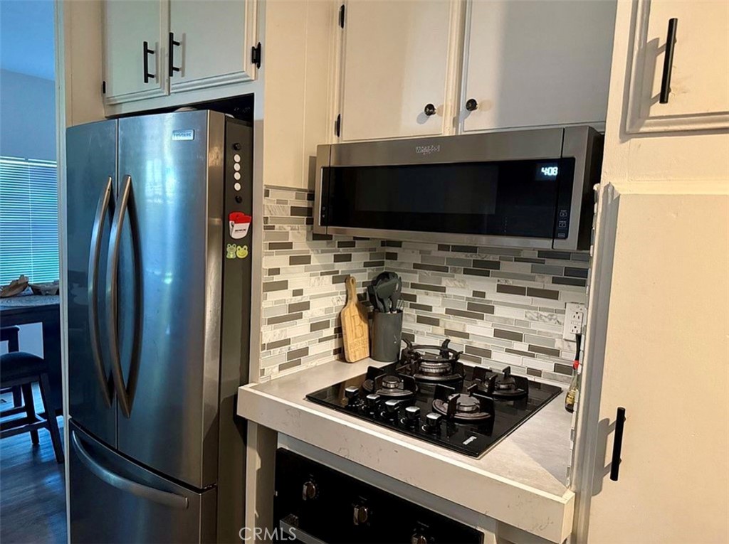 22601 Bear Valley Road, Unit 63 Apple Valley, CA 92308 - Photo 10 of 31 a kitchen with stainless steel appliances a stove a refrigerator and a cabinets