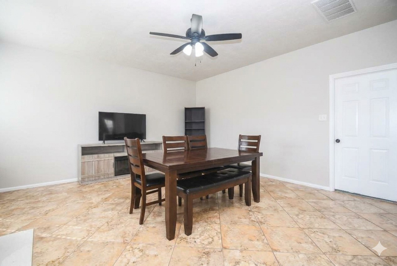 14407 Andrea Way Lane Houston, TX 77083 - Photo 12 of 29 This room features tiled flooring and a ceiling fan. The space is open and bright, with neutral walls for easy personalization.