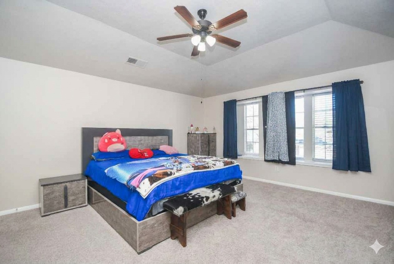 14407 Andrea Way Lane Houston, TX 77083 - Photo 21 of 29 a bedroom with a bed and a chandelier