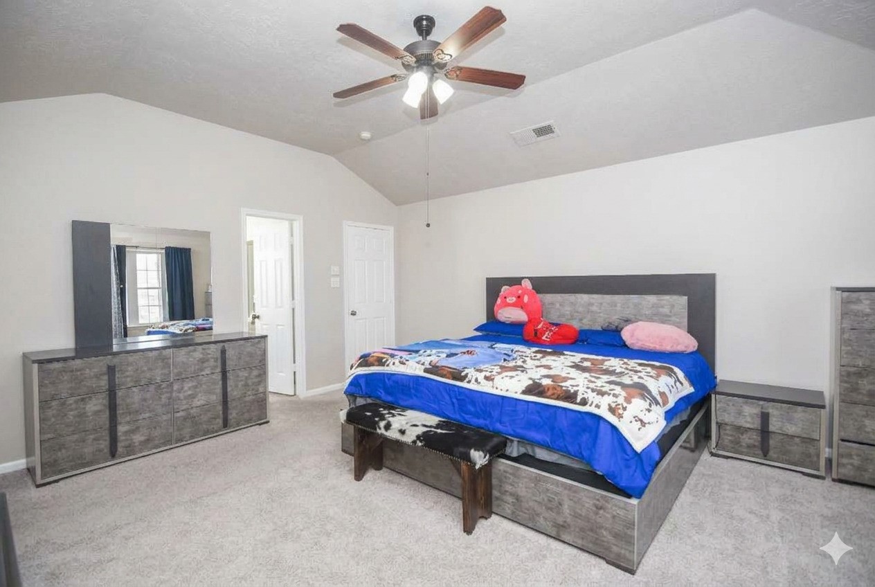 14407 Andrea Way Lane Houston, TX 77083 - Photo 22 of 29 a bedroom with a bed and a chandelier