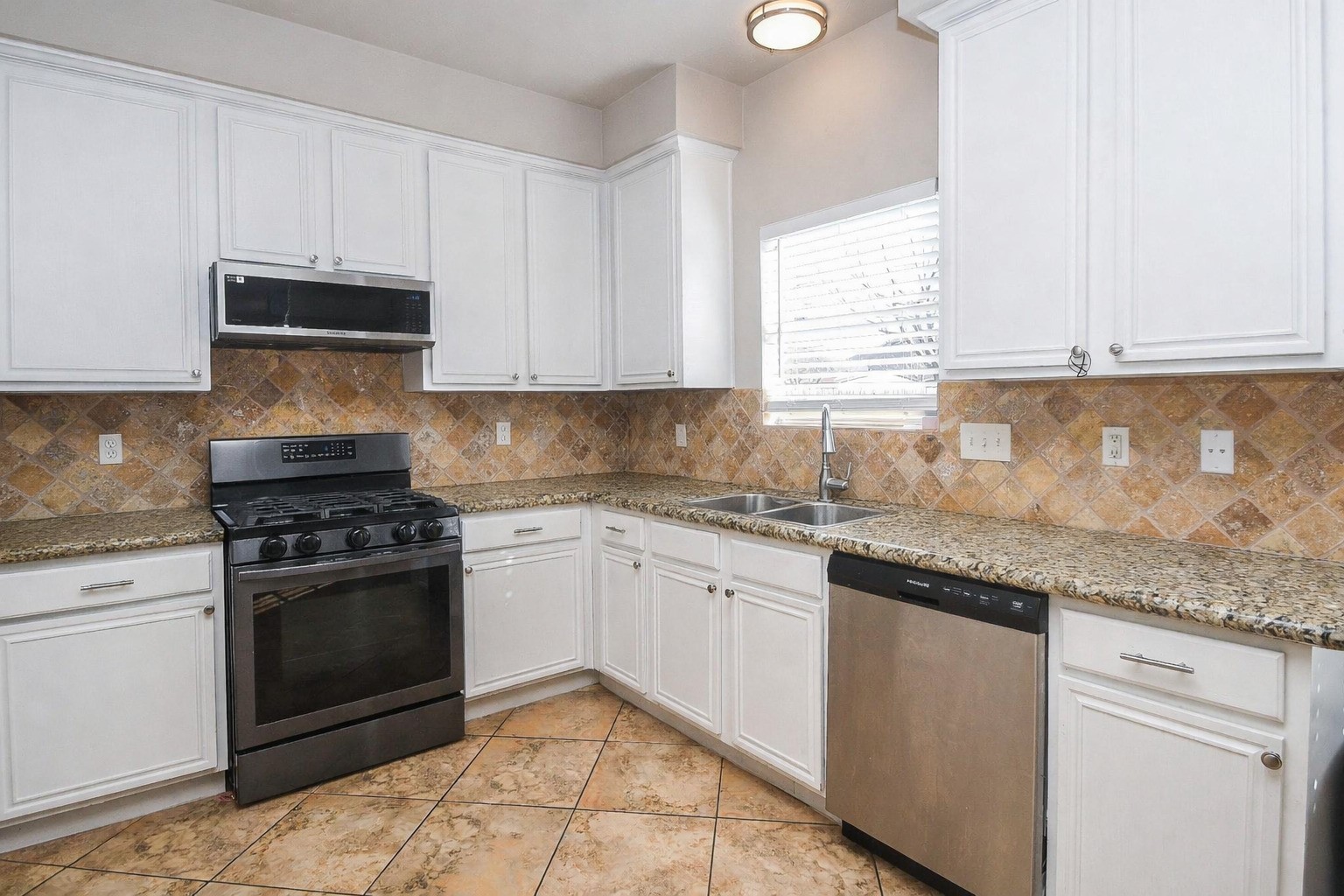 14407 Andrea Way Lane Houston, TX 77083 - Photo 3 of 29 a kitchen with granite countertop white cabinets and appliances