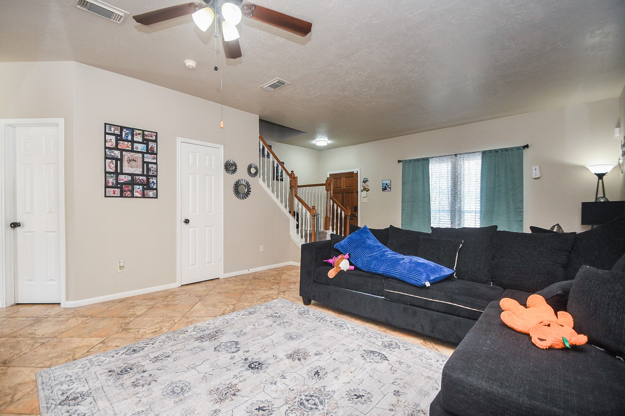 14407 Andrea Way Lane Houston, TX 77083 - Photo 8 of 29 a living room with furniture and a chandelier