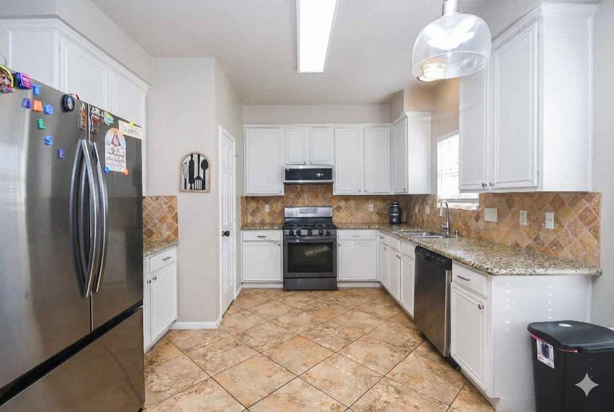 14407 Andrea Way Lane Houston, TX 77083 - Photo 9 of 29 a kitchen with granite countertop a refrigerator oven a sink and dishwasher