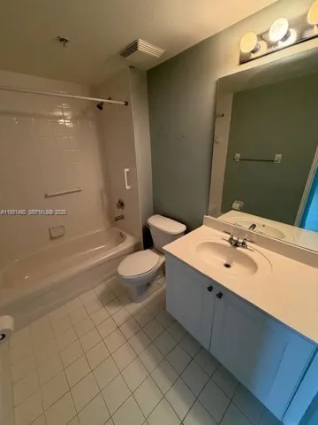 a bathroom with a double vanity sink toilet and shower