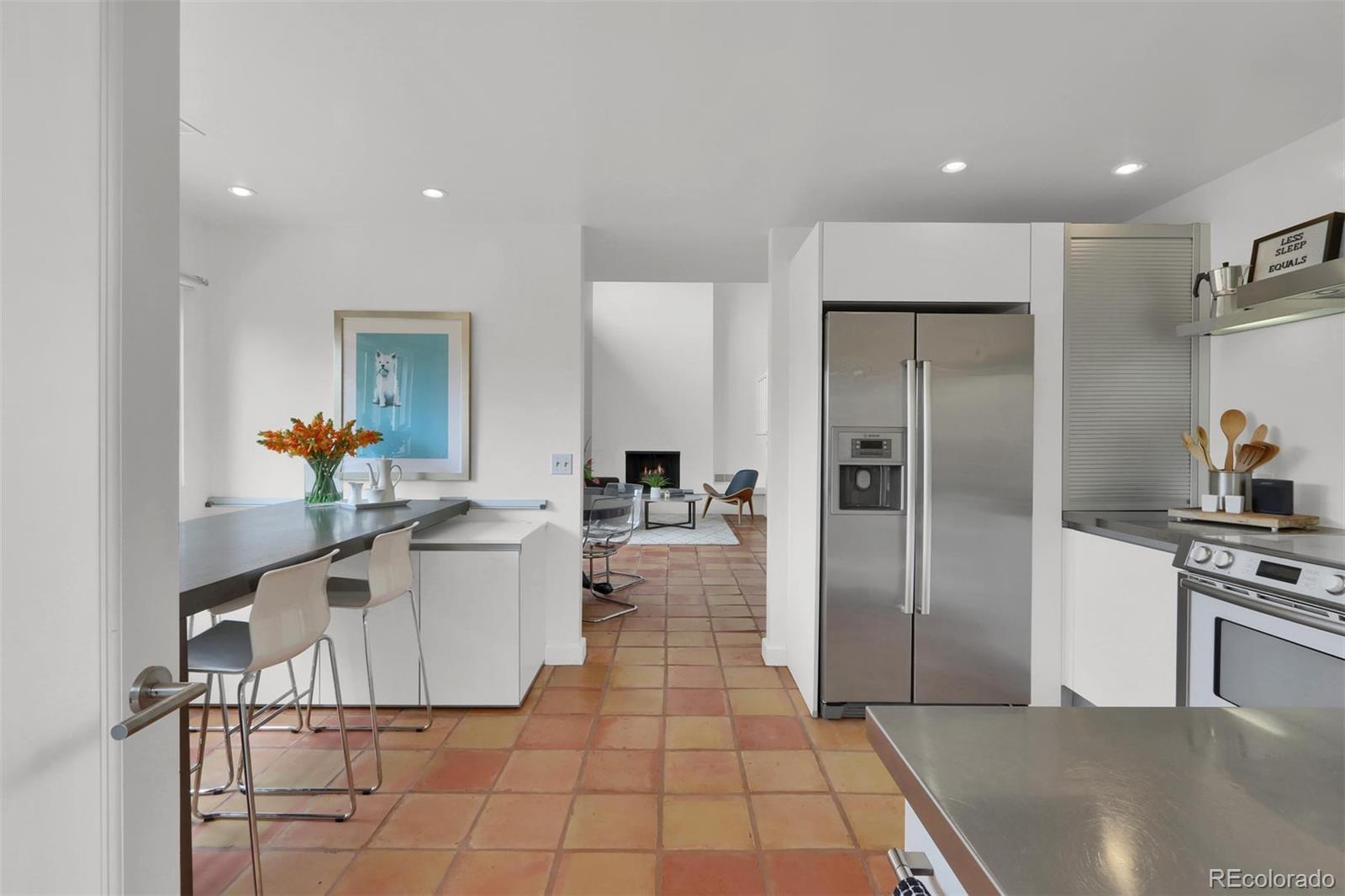 855 Front Range Road Littleton, CO 80120 - Photo 11 of 34 a kitchen with stainless steel appliances a refrigerator and a stove