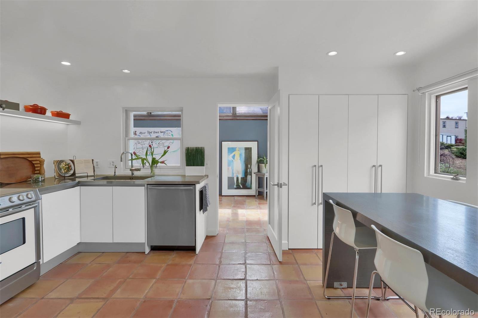 855 Front Range Road Littleton, CO 80120 - Photo 13 of 34 a kitchen with a sink and cabinets