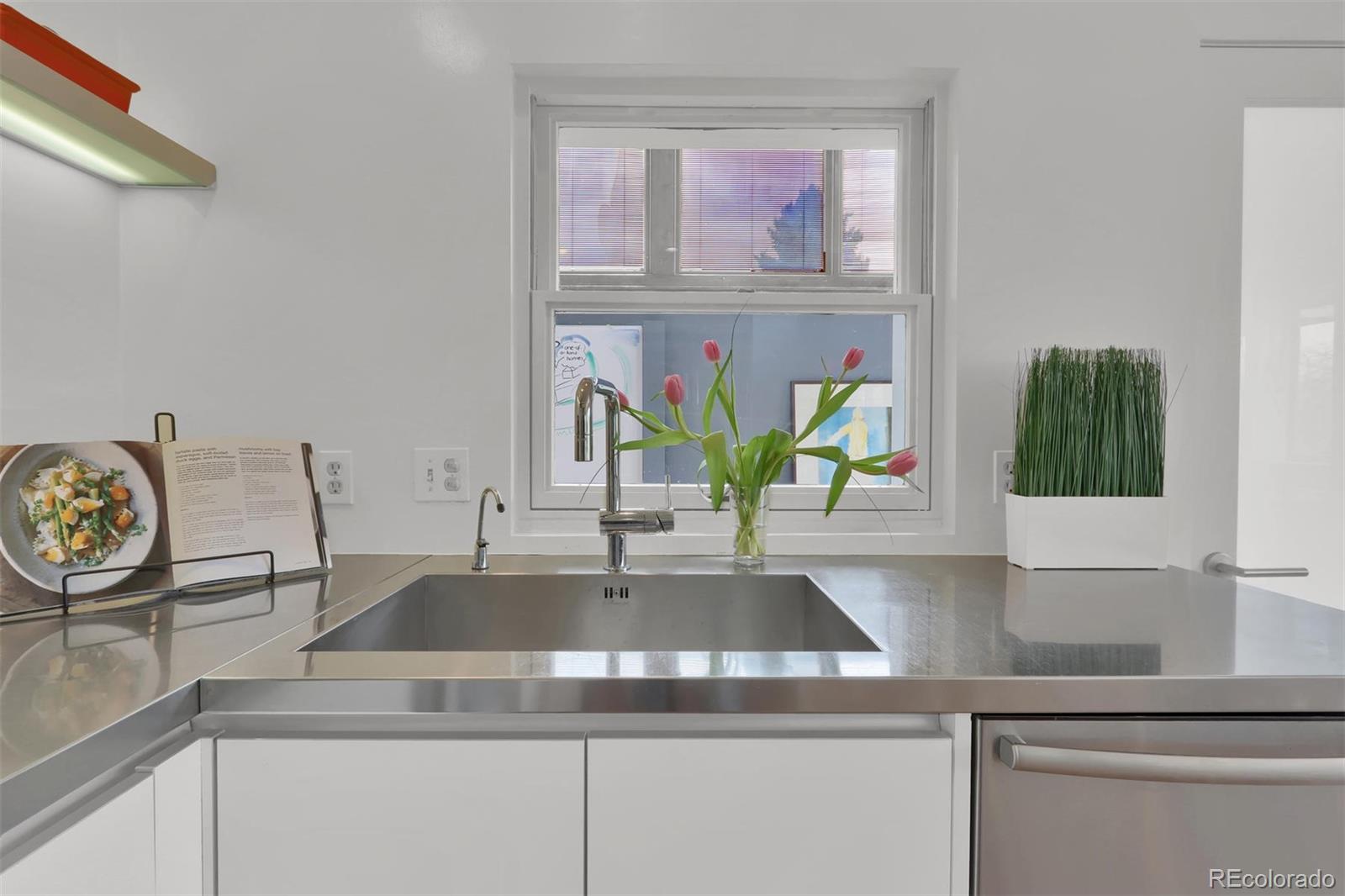 855 Front Range Road Littleton, CO 80120 - Photo 14 of 34 a view of kitchen sink with wooden floor