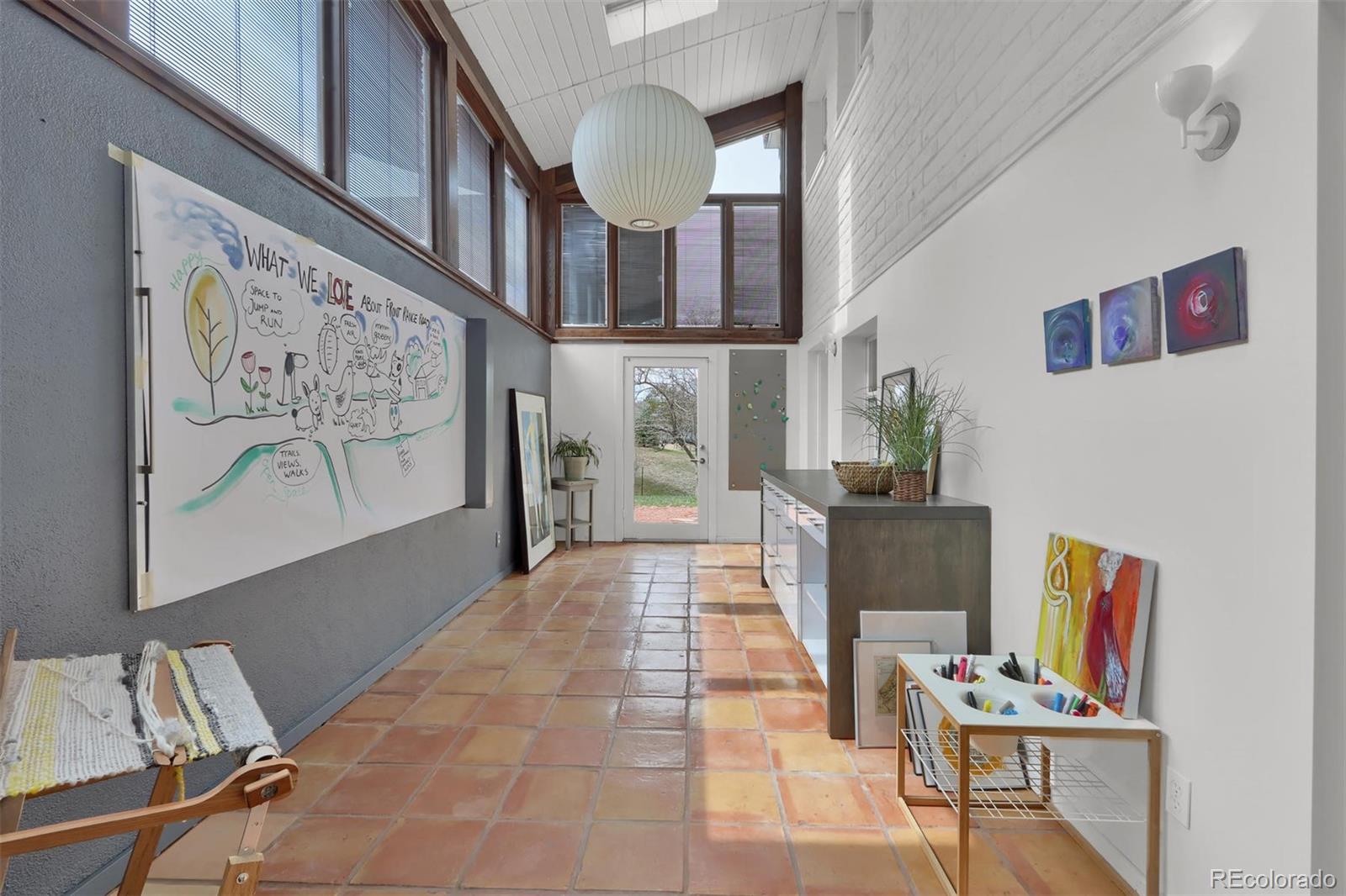 855 Front Range Road Littleton, CO 80120 - Photo 19 of 34 a living room with furniture and a flat screen tv