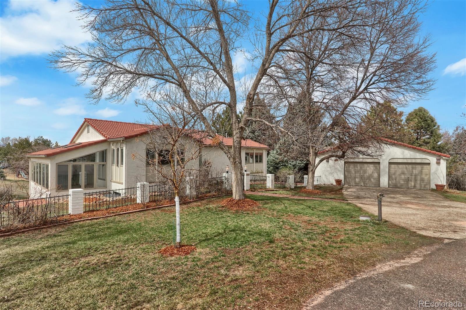 855 Front Range Road Littleton, CO 80120 - Photo 2 of 34 a house that has a tree in front of a house