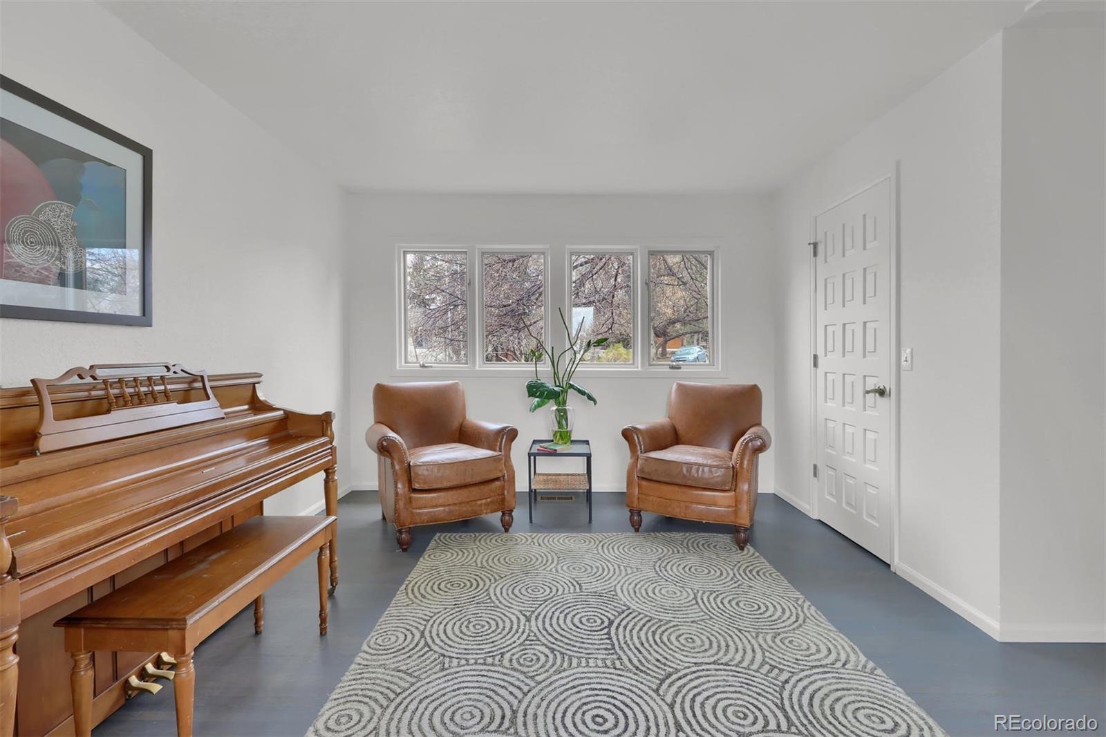 855 Front Range Road Littleton, CO 80120 - Photo 22 of 34 a living room with furniture and a large window