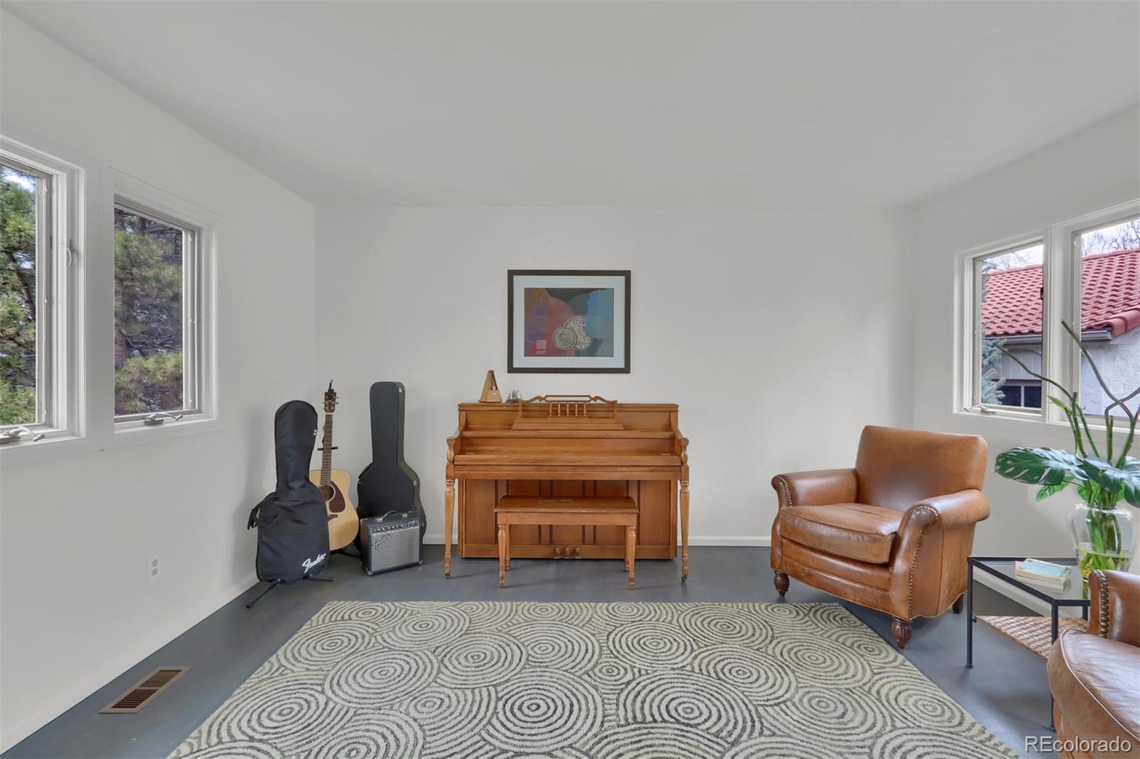 855 Front Range Road Littleton, CO 80120 - Photo 23 of 34 a living room with furniture a couch and dresser