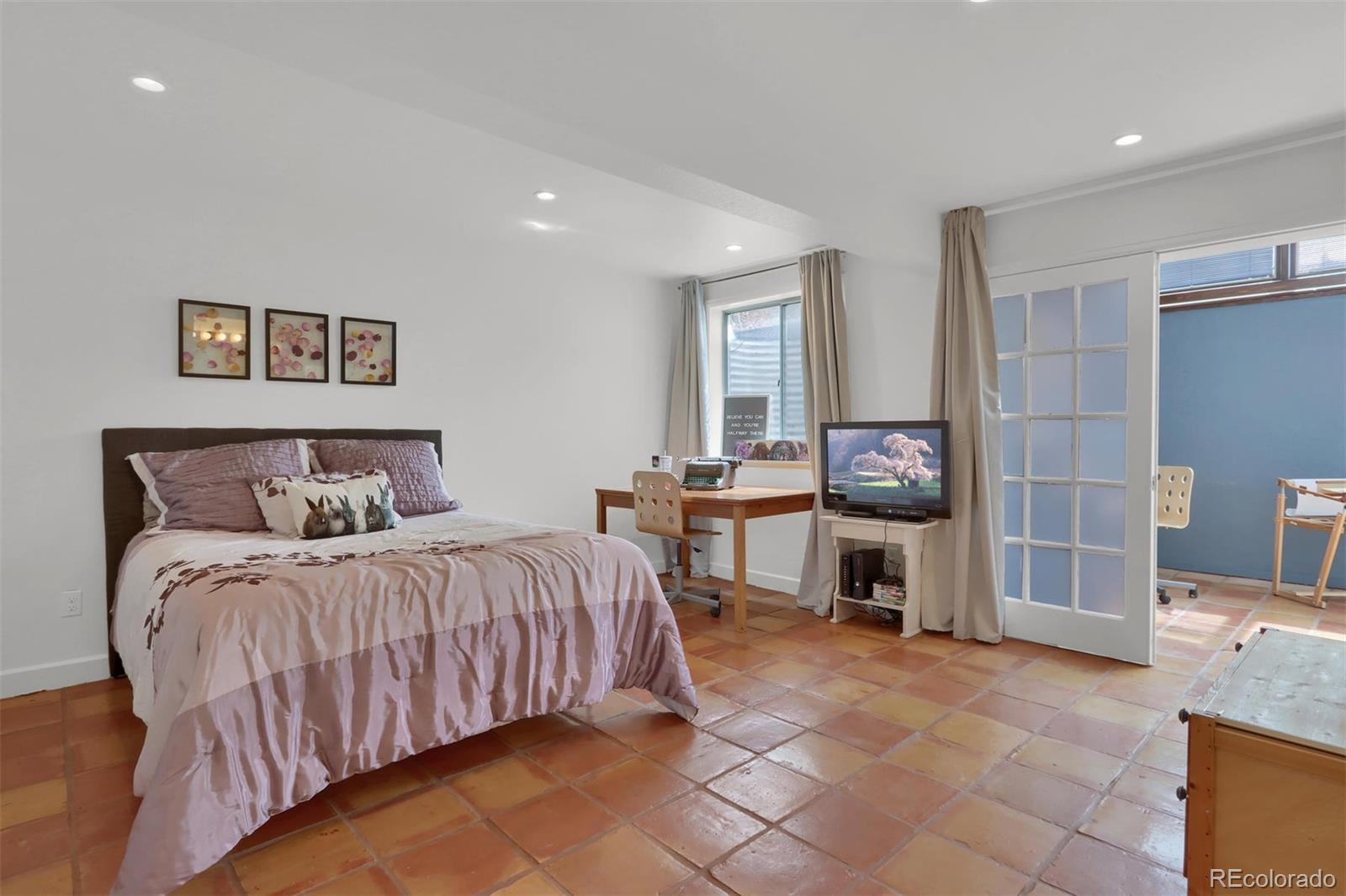 855 Front Range Road Littleton, CO 80120 - Photo 25 of 34 a bedroom with a bed and furniture