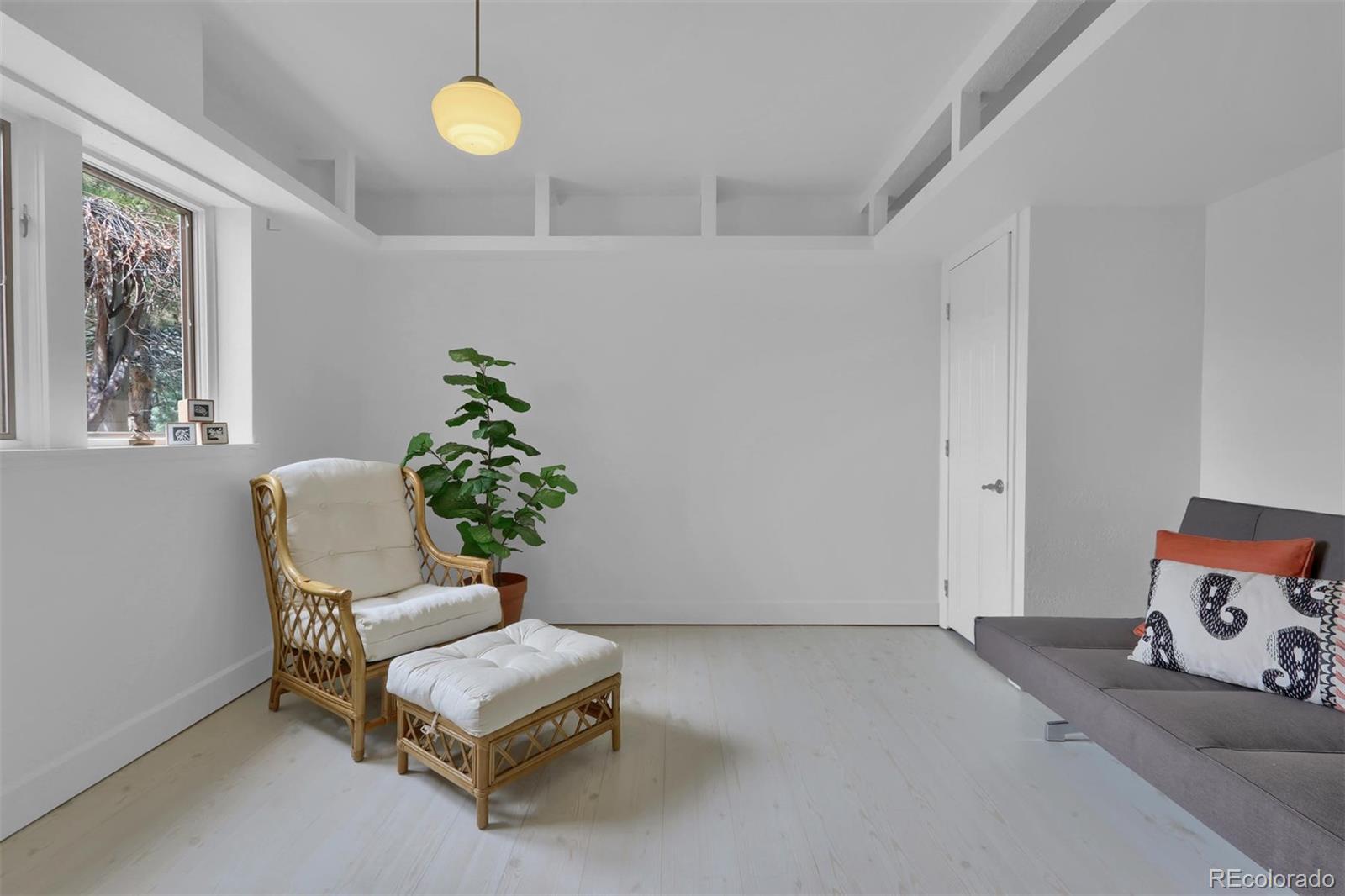 855 Front Range Road Littleton, CO 80120 - Photo 26 of 34 a living room with furniture and a potted plant