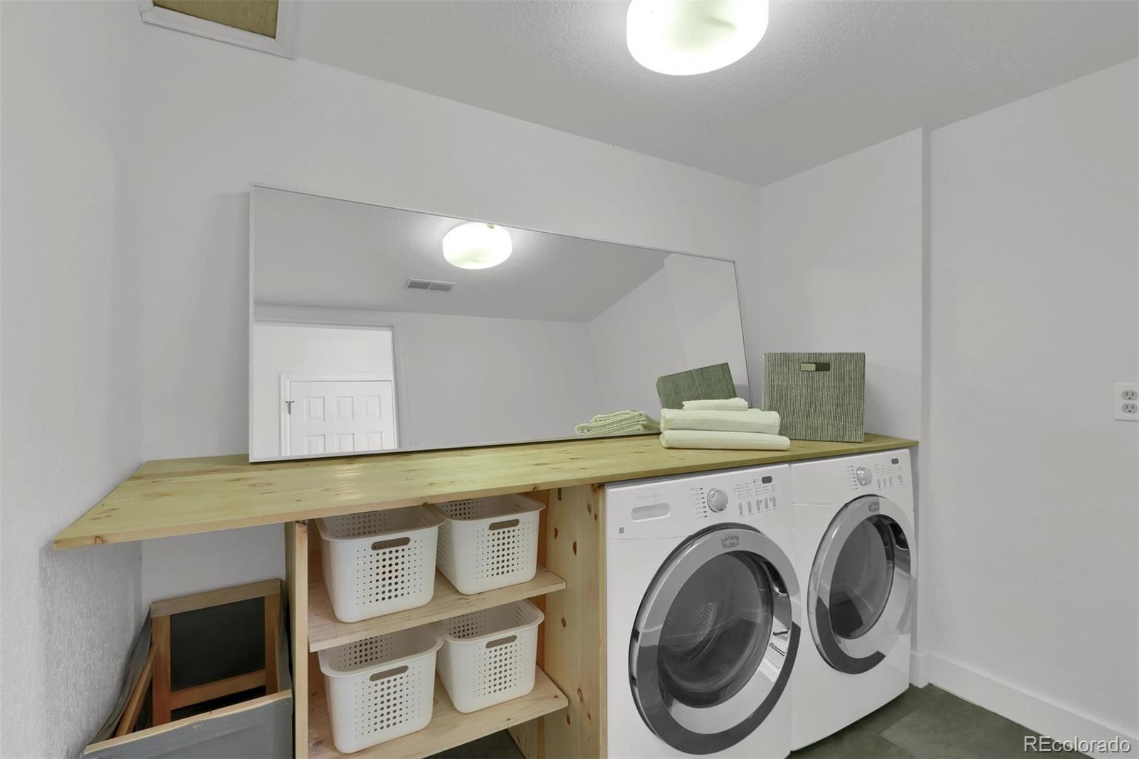 855 Front Range Road Littleton, CO 80120 - Photo 27 of 34 a utility room with dryer and washer