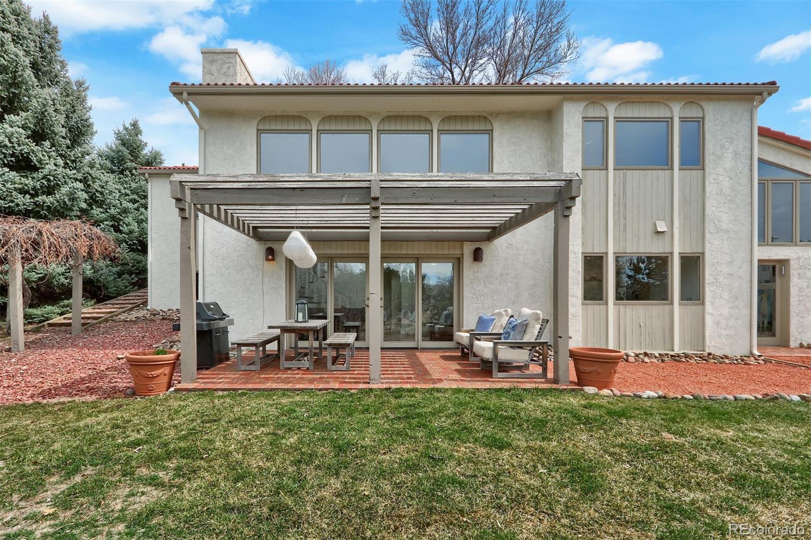 855 Front Range Road Littleton, CO 80120 - Photo 29 of 34 a view of a house with backyard sitting area and garden